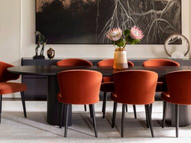 black dining table with dark orange chairs