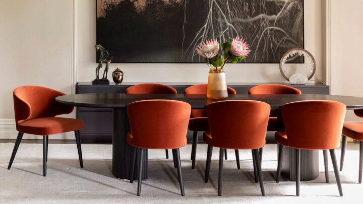 black dining table with dark orange chairs