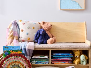 kids book nook with books in bottom sections and chair with cushion to sit on