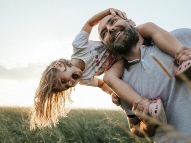 Father giving his daughter a piggy back ride