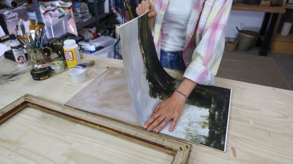 pressing a photo print onto a cardboard backing