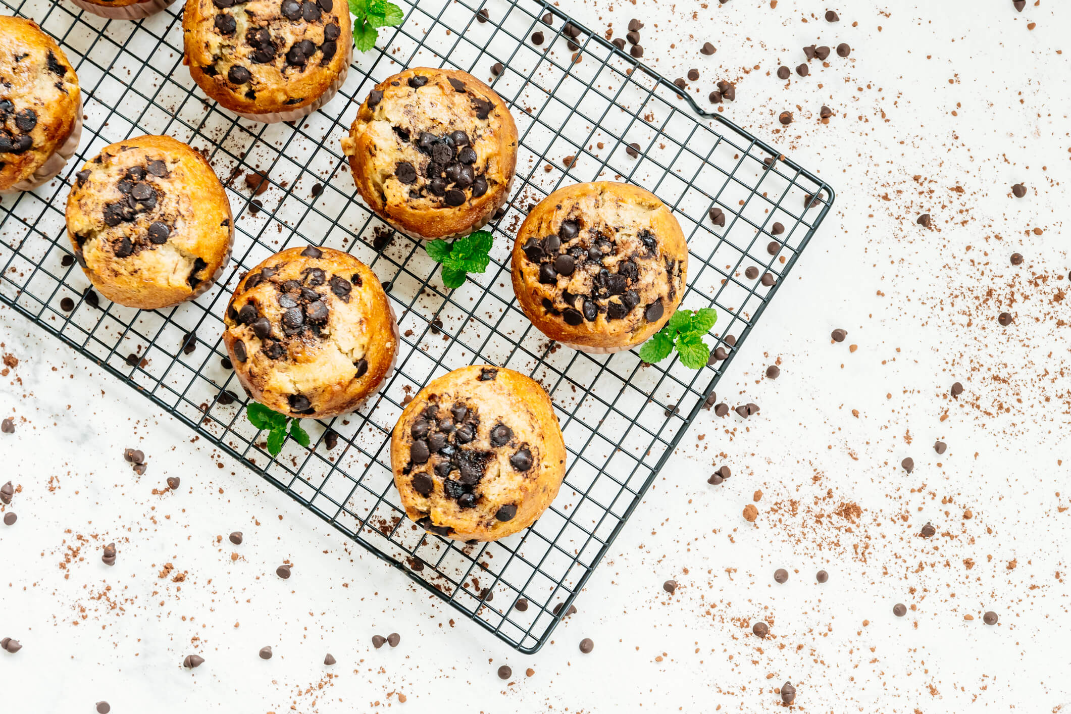 Fresh chocolate chip muffins on a baking tray